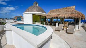 a villa with a swimming pool and a house at Casa Javi- Ocean Front located Mid Isla Mujeres in Isla Mujeres