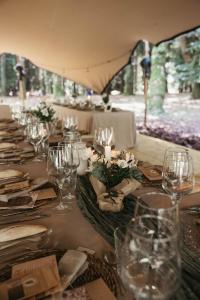 a long table with wine glasses and candles on it at Balneario Casa Pallotti in Carranza