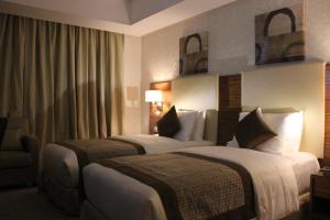 a hotel room with two beds and a window at فندق الشهباء جده Al Shahba Jeddah in Jeddah