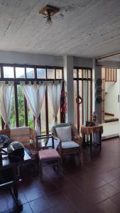 a living room with a couch and chairs and windows at Charly's House in Mar del Plata