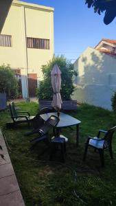 a table with an umbrella sitting on top of it at Charly's House in Mar del Plata