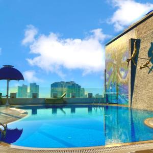 a large swimming pool on top of a building at Swiss-Belhotel Seef Bahrain in Manama