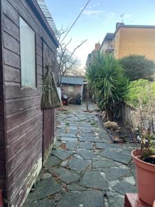 a stone walkway next to a house with a bag on the side at Spacious 2 Bedroom Apartment in Zone 2 LONDON in London