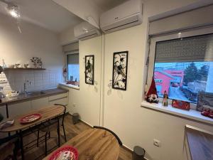 a kitchen with a dining table and a window at Bliss city apartments-Taurunum 1 in Belgrade