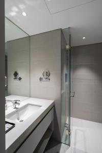 a bathroom with a sink and a shower at Linn Hotel Bac Giang in Bắc Giang