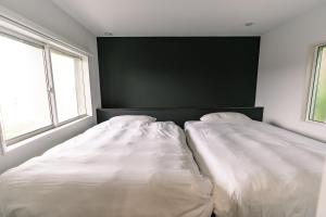 Postel nebo postele na pokoji v ubytování ヴィランス淡路島