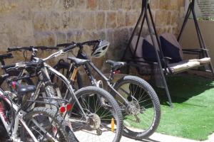 a group of bikes parked next to a swing at Cosy & Calm Central Getaway Modern Guest Suite by Midrachov 1 Queen Bed in Zikhron Ya'akov