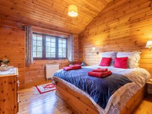 a bedroom with a bed in a log cabin at 1 Bed in Clovelly 00354 in Clovelly