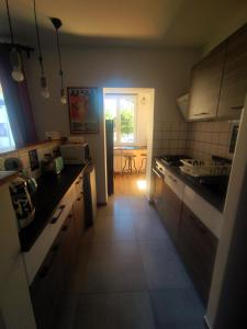 a small kitchen with a table and a window at Apartament Trawertynowy Chrobrego 15 Sopot in Sopot