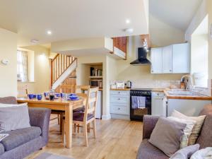 a kitchen and living room with a table and chairs at 2 bed property in Axminster BLOLO in Axminster