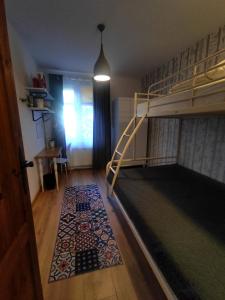 a bedroom with a bunk bed and a rug at Apartament Trawertynowy Chrobrego 15 Sopot in Sopot