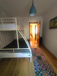 a bedroom with a bunk bed and a rug at Apartament Trawertynowy Chrobrego 15 Sopot in Sopot