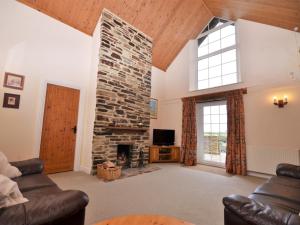 a large living room with a stone fireplace at 3 Bed in Wembury KEEPI in Wembury