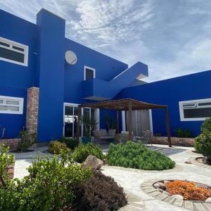 a blue building with a patio in front of it at 3 BDR Villa , unique in Swakopmund in Swakopmund