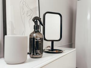 a bottle of wine and a mirror on a counter at Appartement Grünoase - zentrumsnah in Detmold