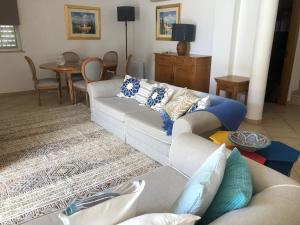 a living room with a couch and a table at Santos Villa in Quinta do Lago in Quinta do Lago