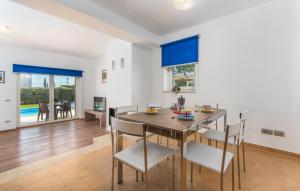 a kitchen and dining room with a table and chairs at Villa Lory in Vabriga