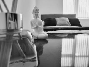 uma estátua de uma mulher sentada no chão numa sala em High Street, 2 bed, newly refurb em Leamington Spa