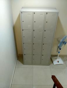 a room with a bunch of lockers and a fan at De Novaren Guesthouse in Bojonggintung