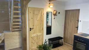 Habitación con puerta de madera y escalera. en Activfarm domki na Kaszubach /domek Madzia en Lipnica