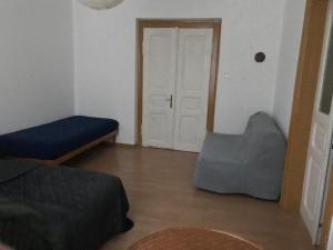 ein Wohnzimmer mit einem Bett und einer Tür in der Unterkunft Apartmán u kostela in Turnov