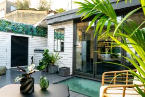 a patio with a pool and a house at Kula London - Covent Garden Garrick St in London