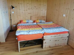 a bedroom with a bed in a wooden room at Ostseeseele in Parin