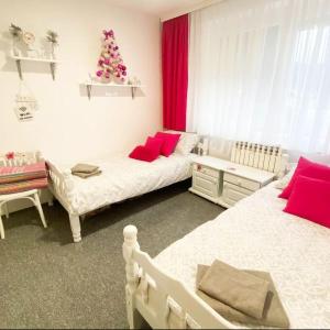 a bedroom with two beds and a christmas tree at Planinska kuća Jahorinka in Pale