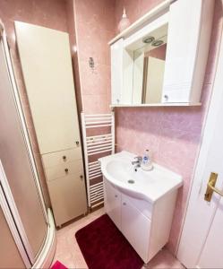 a bathroom with a white sink and a shower at Planinska kuća Jahorinka in Pale