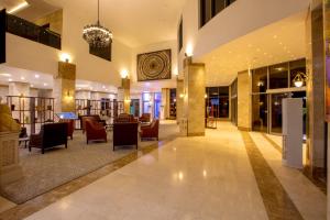 a lobby of a hotel with chairs and a chandelier at JOHNWOOD HOTEL by Bolton in Wuse