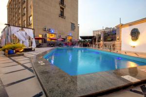 a large swimming pool in front of a building at JOHNWOOD HOTEL by Bolton in Wuse