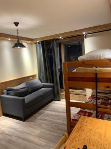 a room with a bed and bunk beds in it at ski-in ski-out 05 in Val Thorens