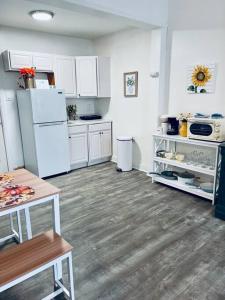 a kitchen with white appliances and wooden floors at Cozy 1BR with Patio in the Heart of Albany in Albany