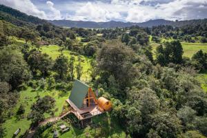 an aerial view of a house in the middle of a field at La Gloria Reserva Forestal in La Calera