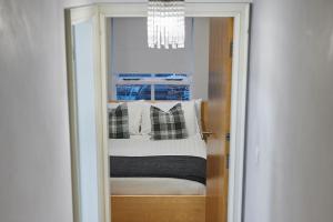 a room with a bed with a chandelier and a window at Host & Stay - The Ivanhoe Retreat in Liverpool