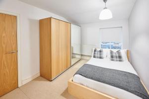 a bedroom with a bed and a wooden cabinet at Host & Stay - The Ivanhoe Retreat in Liverpool