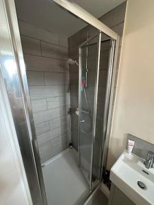 a shower in a bathroom with a glass shower stall at Barn conversion with hot tub in Lincoln