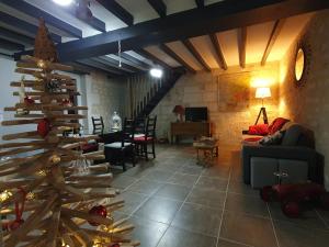 a living room with a christmas tree in the middle at Gite de la Guernouille in Luçay-le-Mâle