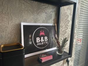 a shelf with a picture of a bbb suitcase on it at City Stay Juliette in Enschede