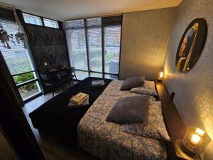 a bedroom with two beds and a lamp and windows at City Stay Juliette in Enschede