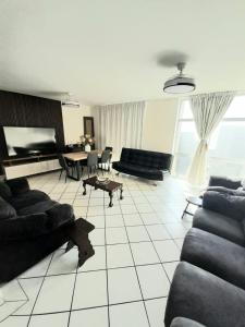 a large living room with couches and a table at Cosy apartment by the sea in Durban