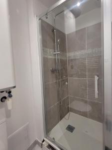 a shower with a glass door in a bathroom at Le Provençal in Saint-Mitre-les-Remparts +5 photos