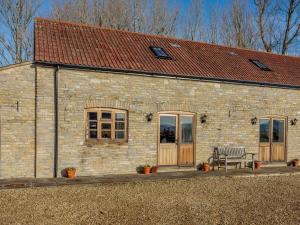 a stone building with a bench in front of it at 1 bed in Somerton 41733 in Babcary