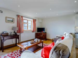 a living room with a couch and a table at 1 bed in Somerton 41733 in Babcary