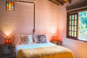 Кровать или кровати в номере Pousada Villa Seychelles
