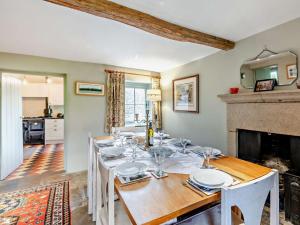 a dining room with a table and a fireplace at 4 bed in Calver PK939 in Curbar
