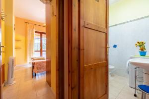 维拉西米乌斯Pentagramma Apartment Villasimius的带木门和水槽的浴室