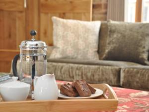 a coffee table with a plate of brownies and a glass appliance at 3 Bed in Leominster 50513 in Pencombe