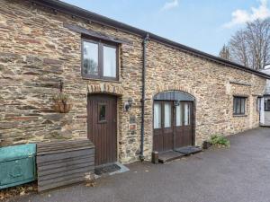 a brick building with two garage doors and a building at 1 Bed in Yelverton 53533 in Yelverton