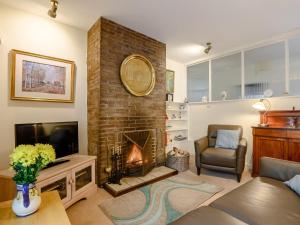 a living room with a fireplace and a television at 2 Bed in Coleford 60103 in Coleford